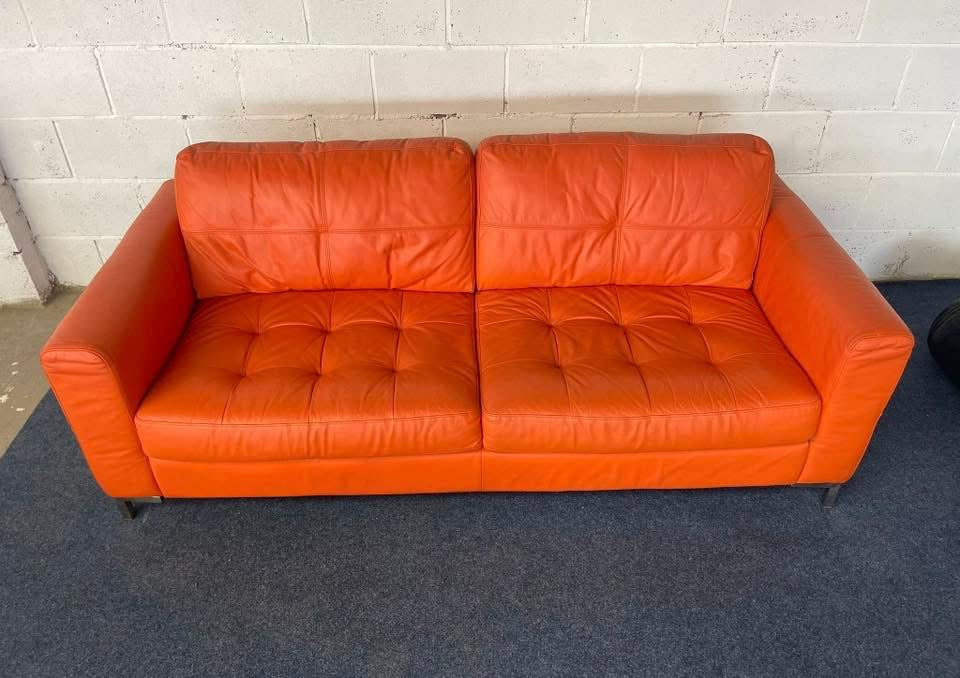 1970s inspired bright orange leather sofa & chair