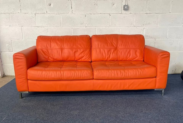 1970s inspired bright orange leather sofa & chair