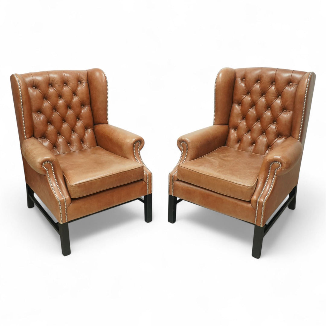 Stylish pair of leather wingback chairs